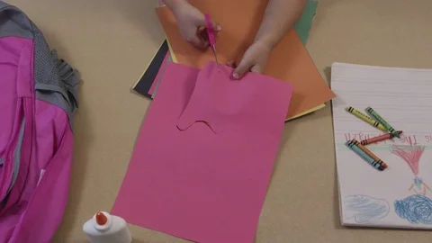 Top view of young child cutting construction paper Stock-Footage 80132127