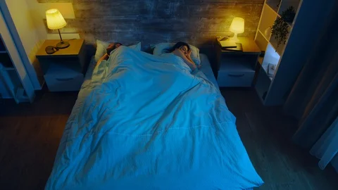 Top view of young couple sleeping 스톡 동영상 129694713