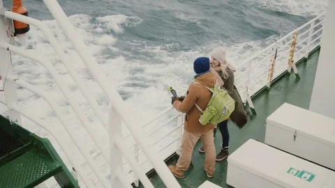 Top view of young couple standing on the board of the ship. Man and woman with Stock Footage 82956737