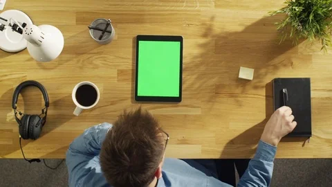 Top View of Young Creative Man Working on His Tablet Computer Sitting  Stock Footage 71454206