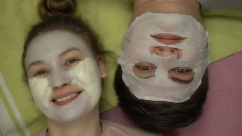 Top view of young funny couple during the cosmetic procedures at home. Stock Footage 100790922