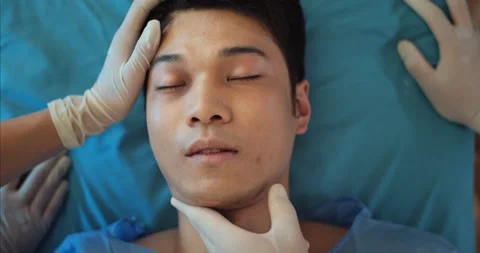 Top view of young guy lying on medical transportation stretcher while paramedic Stock Footage 139053849
