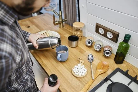 Top view young man making coffee in tiny kitchen travelling with trailer van Stock Photos