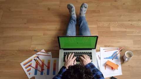 Top view of Young man working with his laptop from his living room Stock Footage 130173411