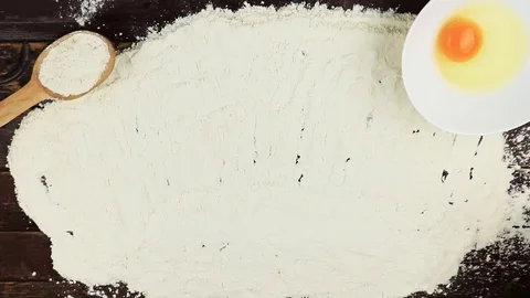 Top view Young man writes a word diet on white flour at wooden desk from above Stock Footage 69119473