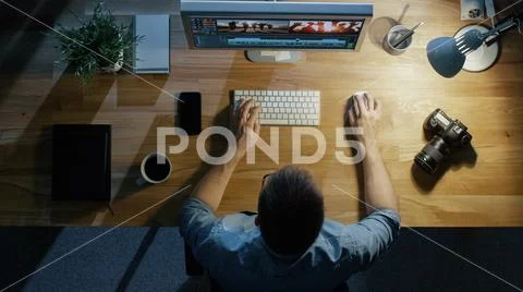 Top View of a Young Photographer Processing photographs on His Laptop. Stock Photos