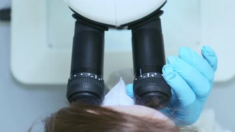 Top view of young scientist looking through a microscope in a laboratory. The Stock Footage 170058959