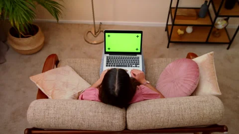 Top View Of Young Woman Using Laptop To Video Cal With Green Screen Stock Footage 147009112
