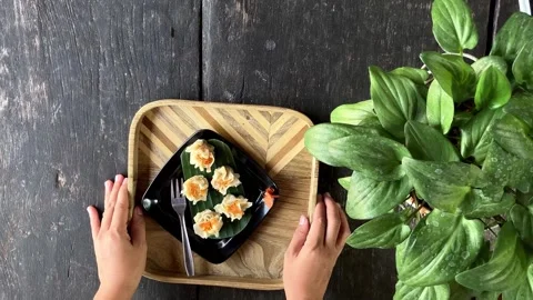 Top View Of A Young Woman's Hand Serves A Plate Of Dim Sum On A Uniquely Pat Stockbeeldmateriaal 337721005