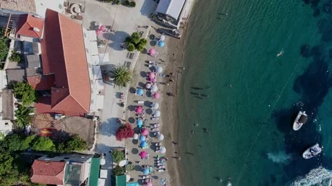 Top view zoom in crowd of relaxed people sunbathing under umbrella enjoying Stock Footage 149470098