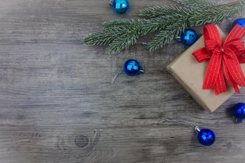 Top view,flat lay gift box and ornament with pine tree branch on grey wooden bac Stock Photos