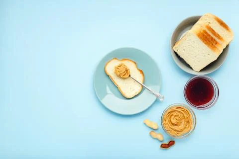 Top view,flat lay process of cooking breakfast, spreading bread, toast with p Stock Photos