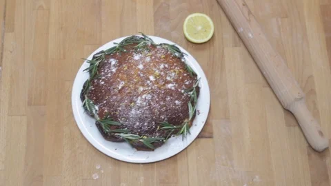 Top Viewof a cake with rolling pin on a wood background with half of a lemon Stock Footage 101309845