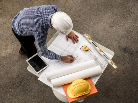 Top viwe, Engineers in helmets planning new project on table. Architect worki Stock Photos