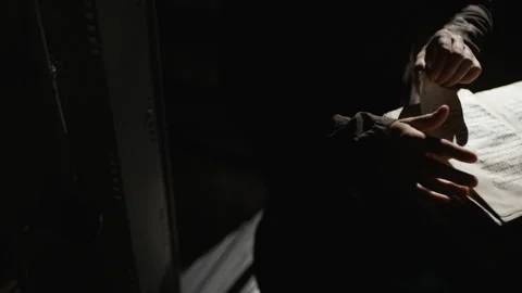 Top voew of Someone is looking for something in the old book Video stock 99091520