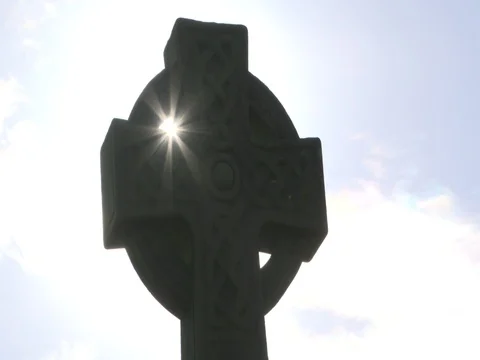 Top of a war memorial cross with setting sun and blue sky Stock Footage 82002093