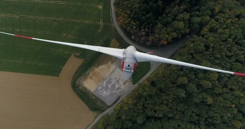 Top wind turbine view. Copter is circling around the windmill in the golden Stock Footage 87476426