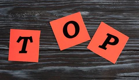 TOP - written on red sheets of paper on a dark beautiful background Stock Photos