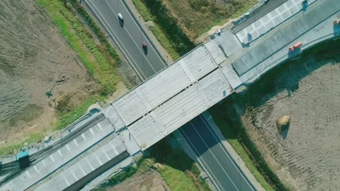Topdown aerial view of roadway junction construction with car traffic. Highway Stock Footage 150949723
