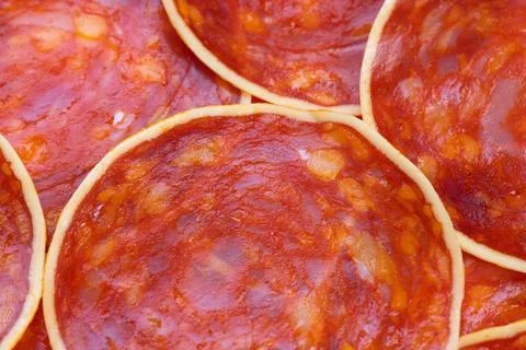 Topdown chorizo rounds on platter creating repeating pattern, overlapping cir Stock Photos