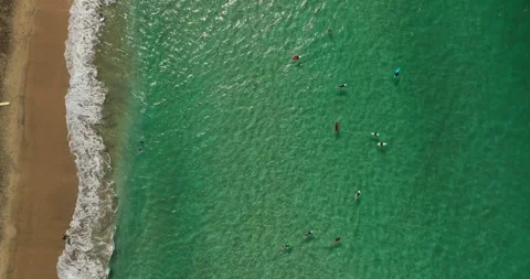 Topdown drone shot of surfers in the sea Stock Footage 343840925