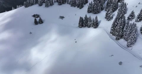 Topdown drone view of a snow-covered mountain landscape at an altitude over 1600 Stock Footage 205093679