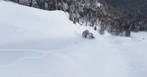 Topdown drone view of a snow-covered mountain landscape at an altitude over 1600 Stock Footage 205096316