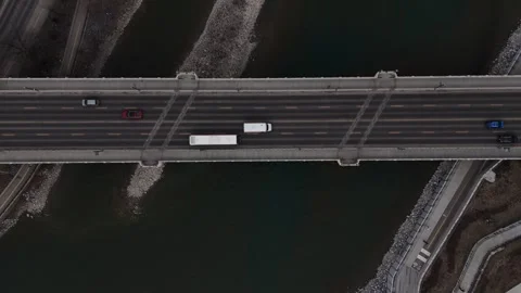 TopDown follow shot of the Centre Street Bridge and Bow River in Downtown Ca Stock Footage 336354982