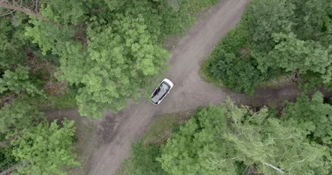 Topdown shot of an electric car in the forest Stock Footage 164958852