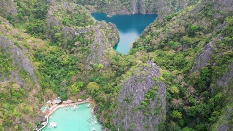 Top‑Down View of Hidden Jungle‑Clad Lagoon Surrounded by Karst Peaks 動画素材 311709040