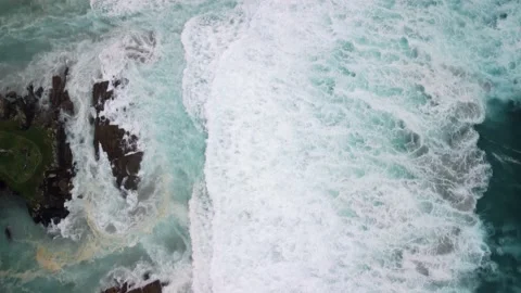 Topdown View Of Rough Ocean With Foamy Waves Crashing Over Cliffs In Caion Beach 動画素材 237068210
