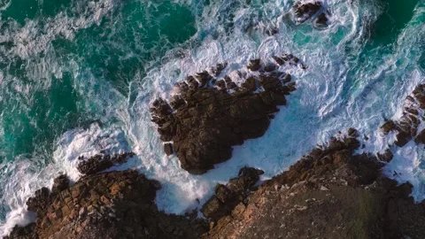Topdown View Of Seafoam Breaking Over Rocks Stock Footage 317745857