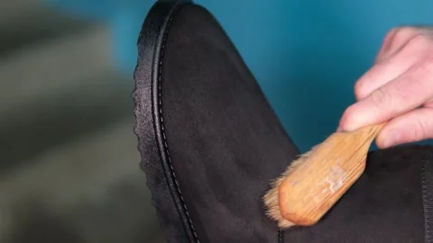 Topic care and brushing warm shoes expertly with small brush in workshop Stock Footage 305903857