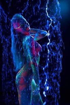 Topless Girl with ultraviolet bodyart and bursted bubble around her toples... Stock Photos