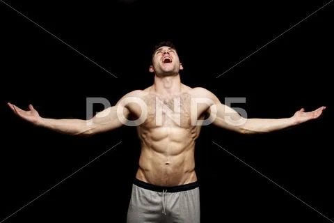 Topless man shouting with his arms outstretched Stock Photos