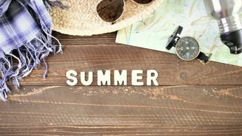 Topo map with compass for weekend hiking on a wood background. Stock Footage