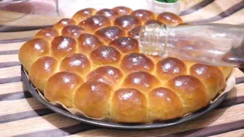 Topping honey on a bread called honey comb bread Stock Footage 327352221