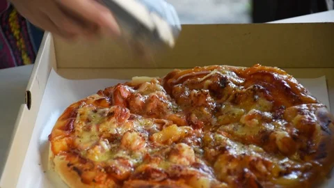 Topping the Pepper on face pizza Stock Footage 128812552