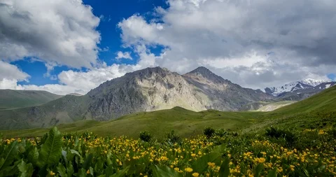 Tops of Mountain Range and smooth movement of clouds among  sharp peaks Stock Footage 105011998