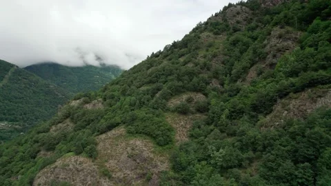 The tops of the mountains in the clouds. View of the slopes from the drone Stock Footage 164298429