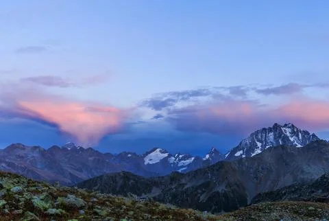 Tops of snow-covered cliffs in the evening Stock Photos