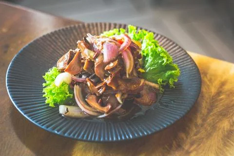 Topshell with onion and chilli padi tossed in special spicy sauces served i.. Stock Photos