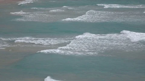 Topside seascape view on beautiful waves crashing on sandy shore. 4k Video stock 70360009