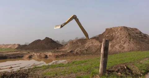 Topsoil excavation using a bucket cran- wide shot Stock Footage 107268649