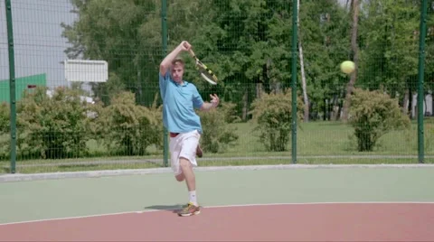 Topspin. Man plays on the base line. Spectacular tennis shot in slow motion. Stock Footage 58282574