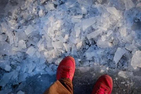 Topview capture of red shoe guy standing on ice ground Stock Photos