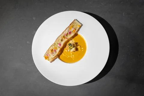 Topview Flat Lay of Garlic Bread with Creamy TomYamKung Soup on white dish .. Stock Photos