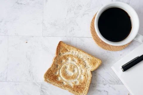 Topview flat lay of working table with coffee and toast bread. Stock Photos