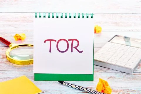 TOR Terms Of Reference in a notebook next to a calculator, magnifying glass,  Stock Photos