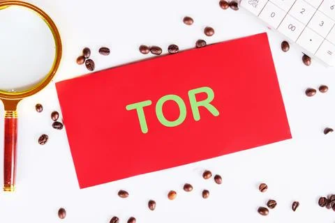 TOR Terms Of Reference on red paper on a white background with coffee beans a Stock Photos